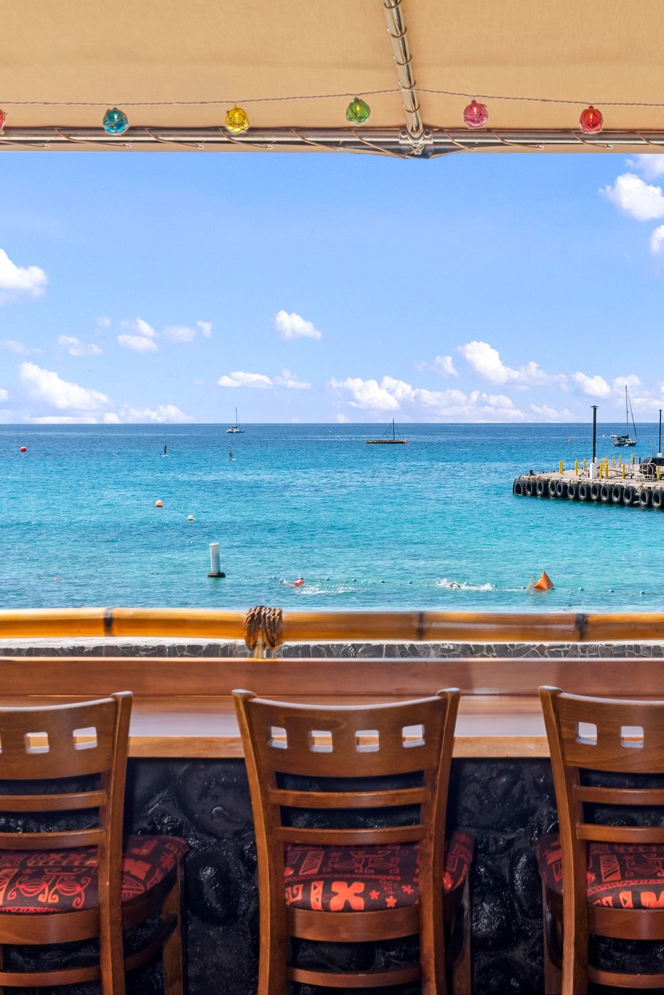 Oceanfront bar seating at Cheeky Tiki